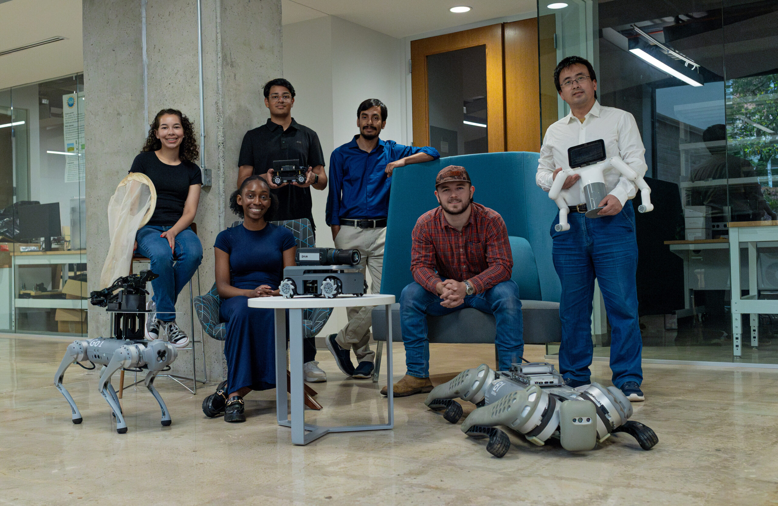 Students posing with agricultural robots